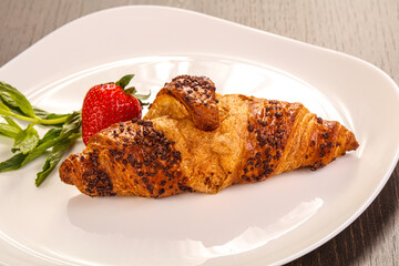 Sweet croissant in the plate