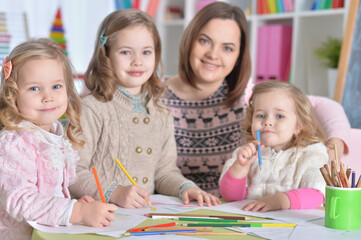 Mother and her three daughters drawing together