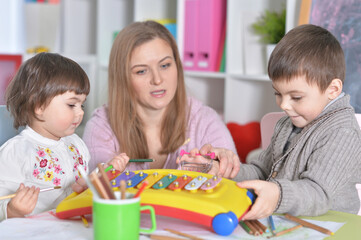Fototapeta premium Mother with children playing together at home
