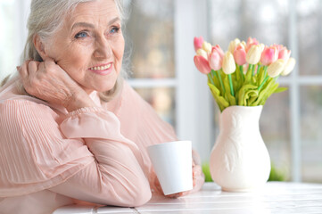 beautiful senior woman drinking tea   at home