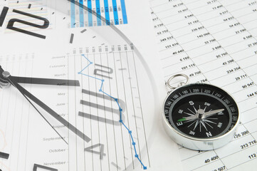Business planning concept. Financial report, compass and clock.