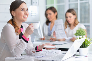 Fototapeta premium young women sit at the table and work in a modern office