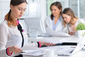 Fototapeta premium young women sit at the table and work in a modern office