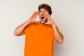Young caucasian man isolated on white background shouting excited to front.