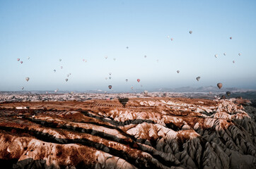 TURKEY, CAPPADOCIA, GOREME:  Aerial scenic view of hot air balloons flying over valleys of Göreme National Park