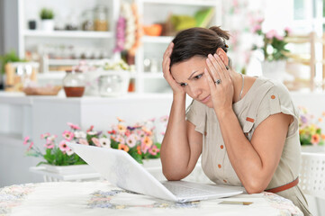 Portrait of tired l young woman working