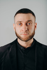 Obraz premium Portrait of handsome stylish man in elegant black suit