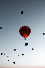 TURKEY, CAPPADOCIA, GOREME:  Aerial scenic view of hot air balloons flying over mountains landscape with fairy chimneys