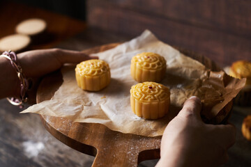 Mooncake a Chinese traditional pastry for Mid-Autumn festival. set on rustic wooden table.