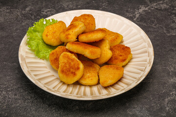 Fried chicken nuggets served salad leaves