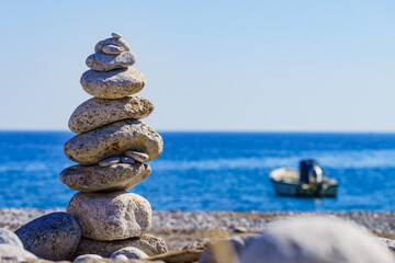 Fototapeta na wymiar Seascape. Beach with stone stack and boat