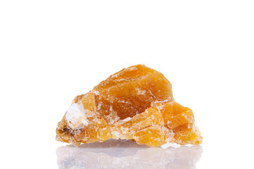 macro mineral stone yellow calcite on a white background