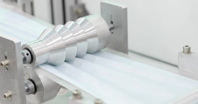 Automated Machine Makes Goffering On Blue Fabric Strip For Surgical Masks - Protection For Corona Virus - Tilt-down, Slow Motion