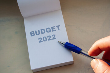 Budget 2022 word on white paper note and pen. Financial