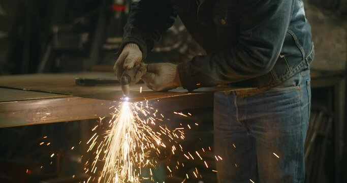 Locksmith cuts metal with a plasma cutter, metalcutting by gas cutter with sparks, 4k Prores HQ