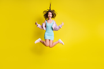 Full body photo of excited pretty person jump high open mouth hair flying isolated on yellow color background