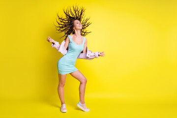 Fototapeta na wymiar Full size photo of happy smiling good mood lovely woman dancing with flying hair isolated on yellow color background