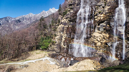 Fototapeta na wymiar The Acquafraggia waterfalls are located in Borgonuovo di Piuro, in the province of Sondrio. The homonymous stream that forms the falls is of glacial origin and originates from Pizzo di Lago at 3,050 m