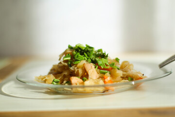 Stewed vegetables with meat in a glass plate