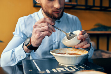 Man eating borscht and pilaf cafe restaurant interior business finance shirt model