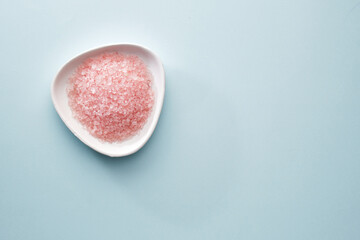 Pink bath salt, dry body massage brush, muslin towels. Body care. View from above.