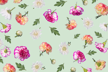 Trendy spring or summer pattern made with different flying flowers and leaves on pastel mint green background, beautiful floral layout.