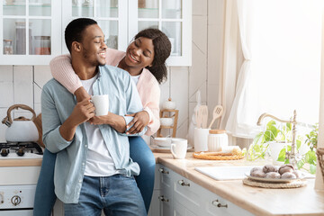 Portrait Of Happy Loving Black Couple Spending Morning Time In Kitchen Together