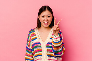 Young chinese woman isolated on pink background showing number two with fingers.