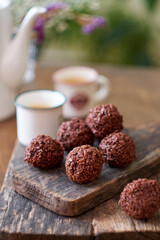 Chocolate coconut balls and coffee. Side view