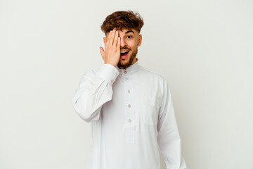 Young Moroccan man wearing a typical arab clothes isolated on white background having fun covering half of face with palm.