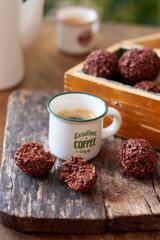 Chocolate coconut balls and coffee. Side view