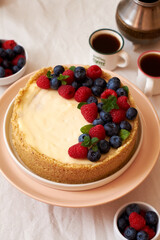 Cheesecake with berries on a white background. Side view.
