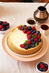 Cheesecake with berries on a white background. Side view.