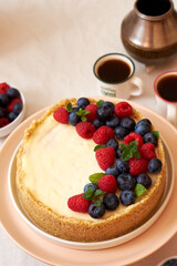 Cheesecake with berries on a white background. Side view.