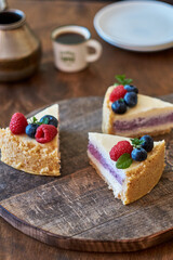 Cheesecake with berries on a wooden background. Side view.