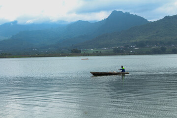 Someone is rowing a boat against a natural background