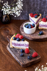 Cheesecake with berries on a wooden background. Side view.