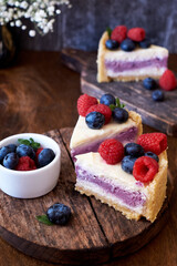 Cheesecake with berries on a wooden background. Side view.