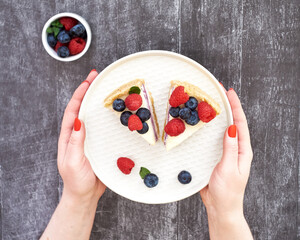 Cheesecake with berries on a grey wooden background. Top view.
