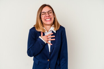 Young business caucasian woman isolated on white background laughs out loudly keeping hand on chest.