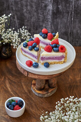 Cheesecake with berries on a wooden background. Side view.