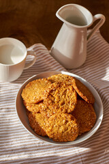 Honey oatmeal chip cookies. Side view. Milk.