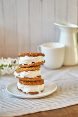 Ice Cream Sandwices: Vanilla ice cream sandwiched between two oatmeal chip cookies on a white background.