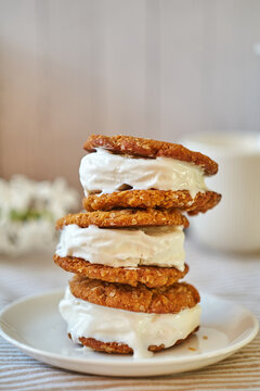 Ice Cream Sandwices: Vanilla Ice Cream Sandwiched Between Two Oatmeal Chip Cookies On A White Background.