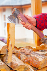 Young man chopping wood with an axe