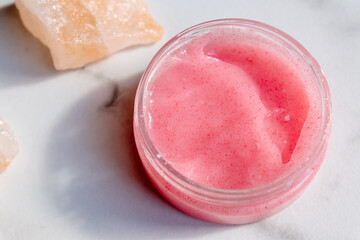 Himalayan salt and pink body or face scrub on marble background. Bath salt. Spa treatment. beauty and relaxation concept.