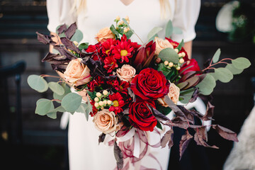 Bride holds beautiful vibrant wedding bouquet
