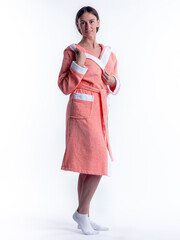 woman in a Bathrobe on an isolated white background with a smile on her face.