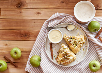scones with apple, pistachios and white chocolate on a wooden background.