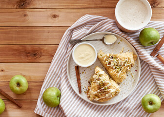 scones with apple, pistachios and white chocolate on a wooden background.